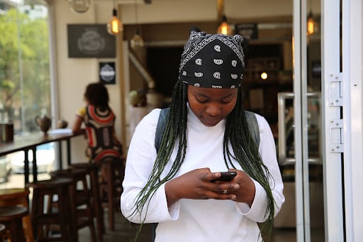 A woman receiving an SMS notifying the availability of her lab results